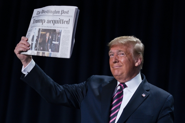 Trump holds up the Washington Post with a Trump acquitted headline