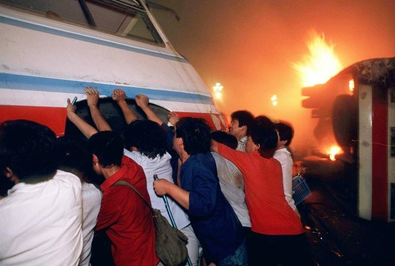Tiananmen Square protests 19890604 - reform demonstrators tip over a bus on Changan Avenue